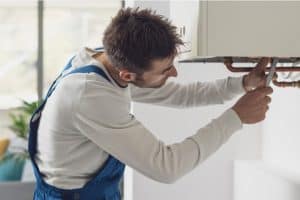 Plombier effectuant la réparation d'une chaudière